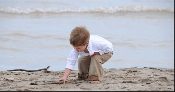 Photograph of boy on shore at Long Point Beach, investment property on the Gold Coast of Ontario, on Lake Erie