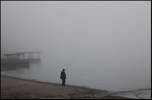 Photograph of fisherman on beach in Normandale, on the Gold Coast in southern Ontario